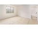A bedroom with a window, showcasing ample natural light and a view into an adjacent bathroom at 7636 Chestnut Hill Rd, Cumming, GA 30041