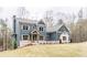 Charming two-story home featuring a well-manicured lawn and classic architectural design at 7636 Chestnut Hill Rd, Cumming, GA 30041