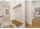 Mudroom with built-in bench, storage, and hooks with a view of the tile floor in the adjoining space at 7636 Chestnut Hill Rd, Cumming, GA 30041