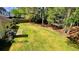 Lush green backyard with mature trees, providing privacy and a serene outdoor space at 223 Cheatham Rd, Acworth, GA 30101