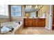 Bathroom features a soaking tub, double sinks, and tile floors at 223 Cheatham Rd, Acworth, GA 30101