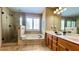 Bright bathroom features double sinks, a soaking tub, and a glass shower at 223 Cheatham Rd, Acworth, GA 30101