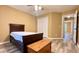 Neutral-toned bedroom with ceiling fan, wood-look floors, closet and wood chest at the foot of the bed at 223 Cheatham Rd, Acworth, GA 30101