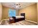 Cozy bedroom showcasing wood-look floors, a ceiling fan and a sunny window with white shutters at 223 Cheatham Rd, Acworth, GA 30101