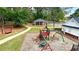 Playground surrounded by trees, picnic tables and a clubhouse in the background at 223 Cheatham Rd, Acworth, GA 30101