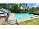 Community pool surrounded by fencing, picnic tables, and a playground in the background at 223 Cheatham Rd, Acworth, GA 30101