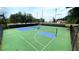 Community tennis courts with a basketball court, surrounded by fencing and trees at 223 Cheatham Rd, Acworth, GA 30101