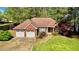 Charming brick home featuring an attached two-car garage, a well-manicured lawn, and mature trees at 223 Cheatham Rd, Acworth, GA 30101