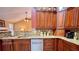 Cozy kitchen boasts granite counters, wooden cabinets, stainless steel dishwasher and mosaic tile backsplash at 223 Cheatham Rd, Acworth, GA 30101