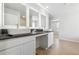Elegant bathroom with double sinks, illuminated mirrors, and granite countertops offering a modern and sophisticated touch at 232 Orwell Dr, Social Circle, GA 30025