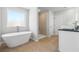 Bright bathroom featuring a modern soaking tub, walk-in shower, and sleek fixtures for a luxurious spa-like experience at 232 Orwell Dr, Social Circle, GA 30025