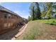 Spacious tiered backyard with brick home and retaining wall with abundant trees at 2745 Veltre Sw Ter, Atlanta, GA 30311