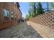 View of a spacious, tiered backyard with a brick retaining wall offering privacy at 2745 Veltre Sw Ter, Atlanta, GA 30311