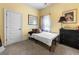 Cozy bedroom with yellow walls, carpet, and neutral decor at 2745 Veltre Sw Ter, Atlanta, GA 30311
