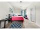 Bright bedroom with blue accents, plush carpet, and natural light from the window at 2745 Veltre Sw Ter, Atlanta, GA 30311