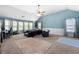 Bedroom featuring carpet, a ceiling fan, lots of natural light, and a blue accent wall at 2745 Veltre Sw Ter, Atlanta, GA 30311