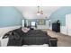Spacious bedroom featuring carpet, a ceiling fan, lots of natural light, and a blue accent wall at 2745 Veltre Sw Ter, Atlanta, GA 30311
