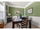 Cozy dining room with stylish wall decor and neutral carpeting, creating a warm and inviting space for meals and gatherings at 2745 Veltre Sw Ter, Atlanta, GA 30311