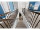 A carpeted staircase with a decorative metal railing leads down from the upper hallway at 2745 Veltre Sw Ter, Atlanta, GA 30311