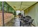 Covered patio with wicker chairs overlooks the backyard with fire pit at 2920 Olde Towne Pkwy, Duluth, GA 30097