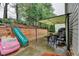 Backyard features a slide, truck, covered patio and built-in retaining wall at 2920 Olde Towne Pkwy, Duluth, GA 30097