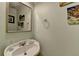 Powder room featuring pedestal sink, framed mirror and decorative art at 2920 Olde Towne Pkwy, Duluth, GA 30097