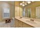 Bathroom featuring dual sinks, a large mirror, and a garden tub at 2920 Olde Towne Pkwy, Duluth, GA 30097
