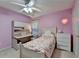 Bedroom with pink walls, large fan, desk area, and closet space at 2920 Olde Towne Pkwy, Duluth, GA 30097