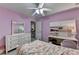 Bedroom featuring pink walls, large fan, and dresser at 2920 Olde Towne Pkwy, Duluth, GA 30097