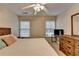 Bedroom featuring white bedding, wood furnishings, and natural light at 2920 Olde Towne Pkwy, Duluth, GA 30097