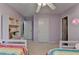 This bedroom features two twin beds, natural light, and unique bookshelf at 2920 Olde Towne Pkwy, Duluth, GA 30097