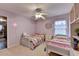 This bedroom features two twin beds, natural light, and unique bookshelf at 2920 Olde Towne Pkwy, Duluth, GA 30097