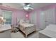 Bedroom with pink walls, large fan, desk area, and closet space at 2920 Olde Towne Pkwy, Duluth, GA 30097