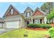 Well-maintained two-story home featuring brick and siding, a manicured lawn, and a two-car garage at 2920 Olde Towne Pkwy, Duluth, GA 30097