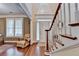 Bright and airy foyer with hardwood floors, a staircase, and views to a living room at 2920 Olde Towne Pkwy, Duluth, GA 30097