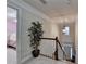 Upstairs hallway with a plant, stairs leading down, and glimpses into bedrooms at 2920 Olde Towne Pkwy, Duluth, GA 30097