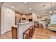 Open kitchen with bar seating, wooden cabinets, stainless steel appliances, and hardwood flooring at 2920 Olde Towne Pkwy, Duluth, GA 30097