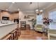 Bright kitchen with bar, wooden cabinets, and view to sitting area with natural light at 2920 Olde Towne Pkwy, Duluth, GA 30097