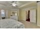 This main bedroom boasts a tray ceiling, fan, and view to the walk-in closet at 2920 Olde Towne Pkwy, Duluth, GA 30097