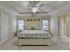 Spacious main bedroom with a tray ceiling, fan, and neutral color palette at 2920 Olde Towne Pkwy, Duluth, GA 30097