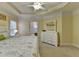 Bright main bedroom features a tray ceiling, ceiling fan, and white dresser at 2920 Olde Towne Pkwy, Duluth, GA 30097