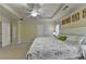 Large main bedroom features a tray ceiling, fan, and wall decor at 2920 Olde Towne Pkwy, Duluth, GA 30097