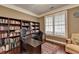 Cozy home office with hardwood floors, built-in shelving, a large desk, and shuttered windows at 2920 Olde Towne Pkwy, Duluth, GA 30097