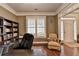 Bright office space with a large desk, hardwood floors, built-in shelves, and a window at 2920 Olde Towne Pkwy, Duluth, GA 30097