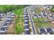 Aerial view of the homes in a neighborhood with tree-lined streets and sidewalks at 4650 Sandy Creek Dr, Cumming, GA 30028