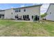 Large, grassy backyard with a patio, porch swing, trampoline, and a fence providing privacy at 4650 Sandy Creek Dr, Cumming, GA 30028