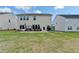 Expansive backyard with well-maintained lawn, patio area, swing, and plenty of space for outdoor activities at 4650 Sandy Creek Dr, Cumming, GA 30028