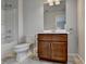 Bathroom featuring a single vanity with wood cabinets, a toilet, and a shower/tub combo at 4650 Sandy Creek Dr, Cumming, GA 30028