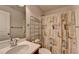 Well-lit bathroom with a neutral color scheme, vanity, and a decorative shower curtain at 4650 Sandy Creek Dr, Cumming, GA 30028