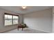 Well-lit bedroom featuring neutral walls, carpeted floor, and a window providing natural light at 4650 Sandy Creek Dr, Cumming, GA 30028